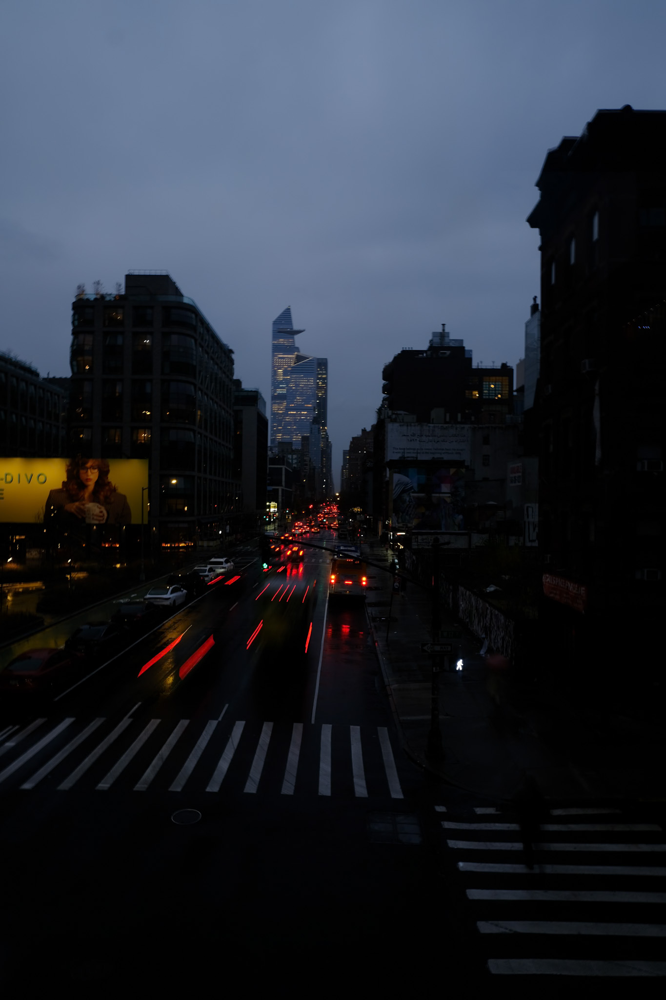 rainy city street with red light trails